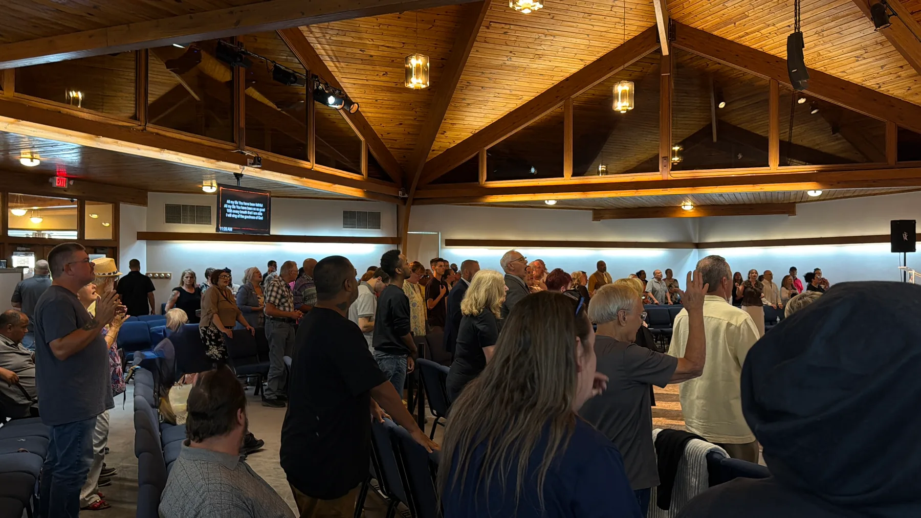 The congregation at Redeemed Life Church standing in worship